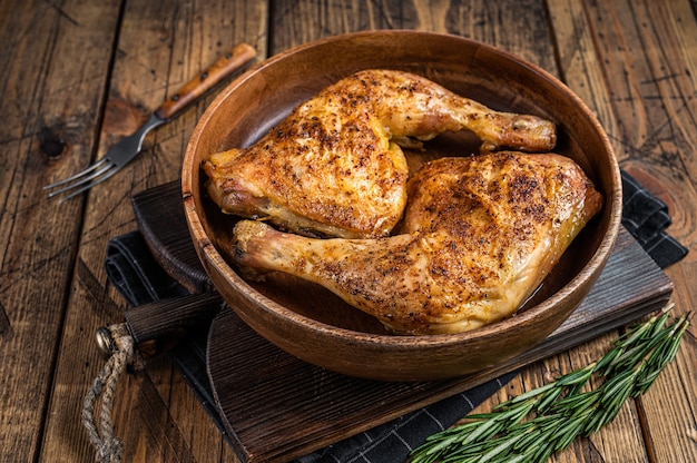 BBQ Grilled chicken legs in a wooden plate with herbs