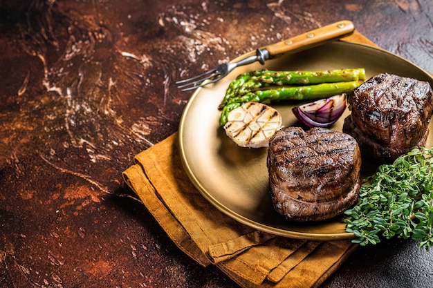 BBQ grilled Fillet Mignon Steak with asparagus beef tenderloin meat Dark background Top view Copy space