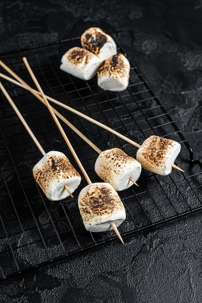 BBQ Grilled Marshmallow on the sticks Black background Top view