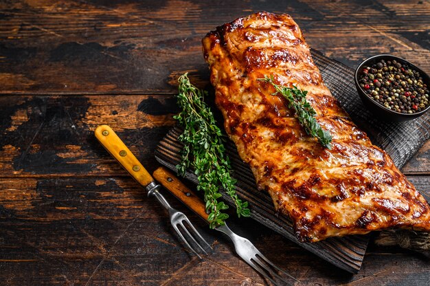 BBQ grilled pork spare ribs on a cutting board. 