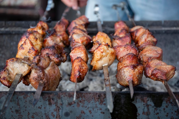 BBQ picnic with kebabs and meat on an open fire on a summer day in the backyard of a private house