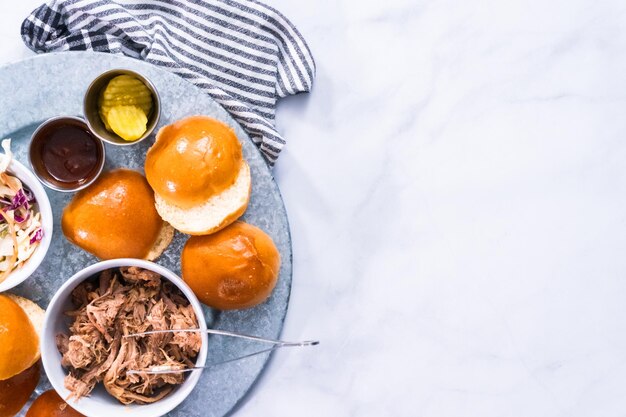 BBQ pulled pork sandwich in shape of small sliders with brioche buns.