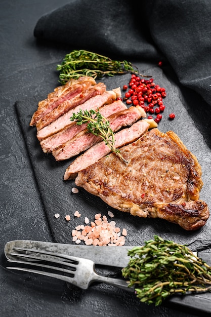 BBQ Striploin steak or strip new York on a stone plate