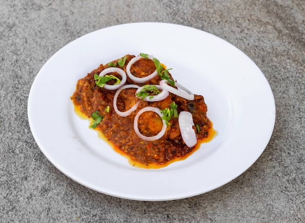 Bbq tandoori chicken served in dish isolated on background top view of indian spices and pakistani food