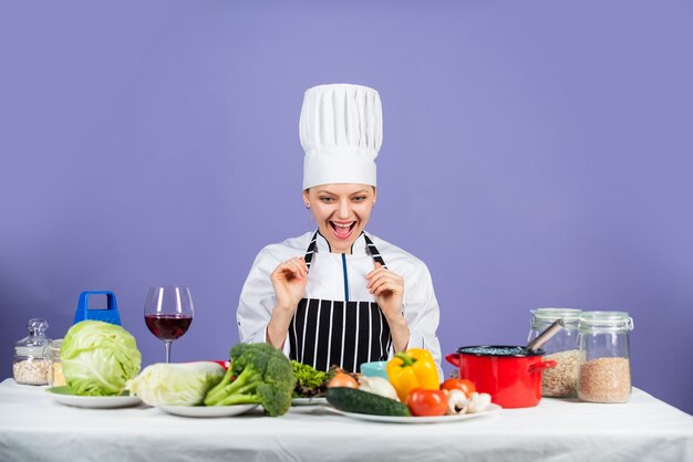 Be All You Can Be. happy chef cooking vegetables. healthy food and diet. woman housewife in cook hat and apron. fresh preparing. full of vitamin. natural and organic. restaurant kitchen lifestyle.