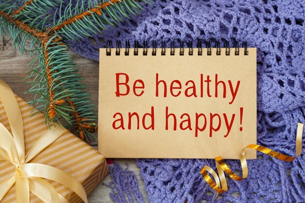 Photo be healthy and happy an inscription on a notebook a scarf and a gift