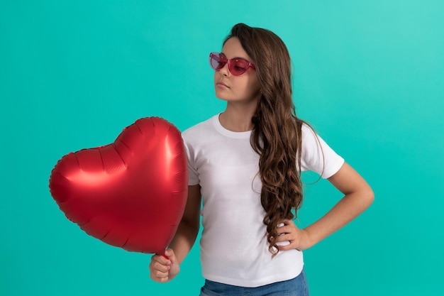 Be my valentine. teen girl with party balloon. love present. serious kid with love romantic gift. sweetheart. valentines sale. portrait of child with heart balloon. happy valentines day.