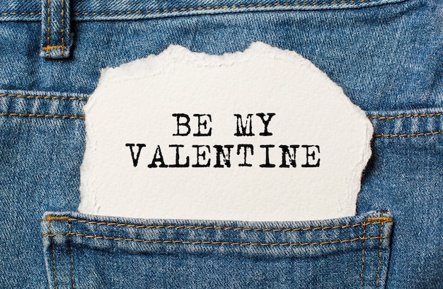 Be my Valentine on torn paper background on jeans love and valentine concept