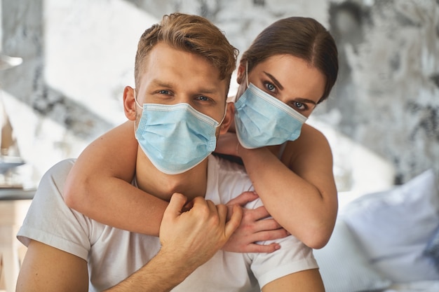 Be responsible. Handsome male person wearing medical mask while leading prevention measures from coronavirus. Care concept