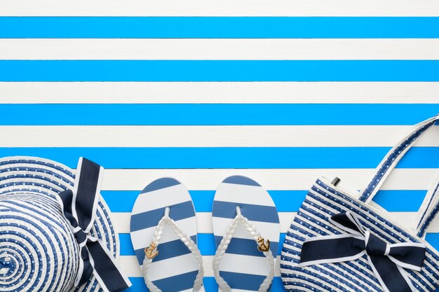 Beach accessories on a blue and white background. Top view, flat lay.