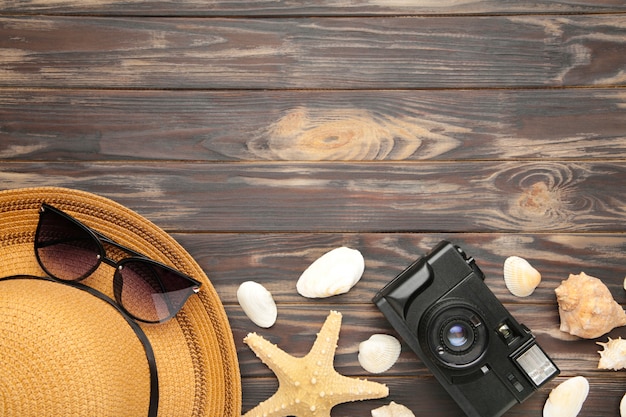 Beach accessories on brown background. Top view