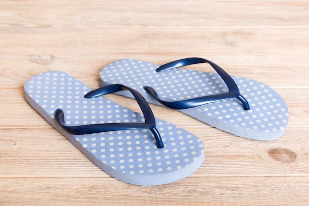 Beach accessories Flip flops and starfish on colored background Top view Mock up with copy space