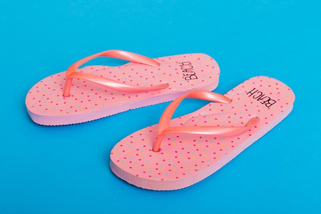 Beach accessories Flip flops and starfish on colored background Top view Mock up with copy space