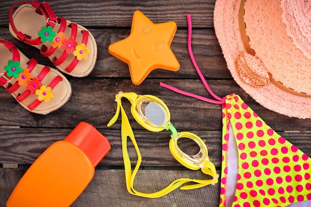 Beach accessories on the old wooden background