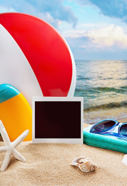 Beach accessories and photos on the memory on a background of sea