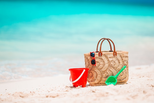 Beach accessories - straw bag, hat and unglasses on the beach