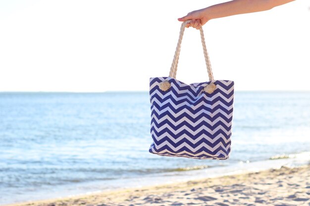 Beach accessories and sunscreens on the sand of the seaside