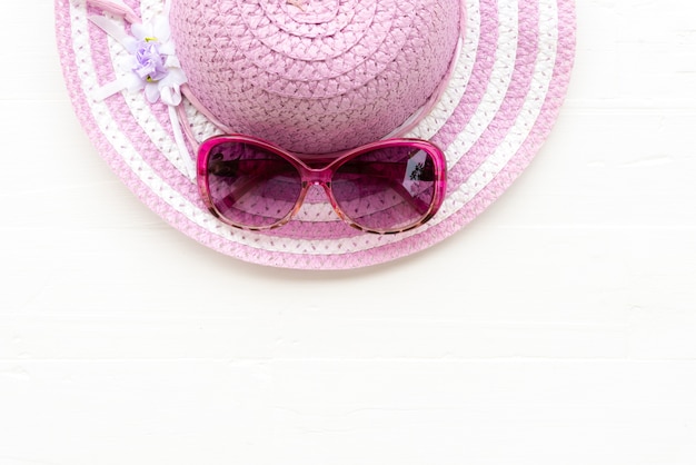 Beach accessories on white paper background for summer concept.