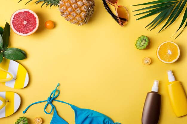 Beach accessories on yellow background Summer vacation