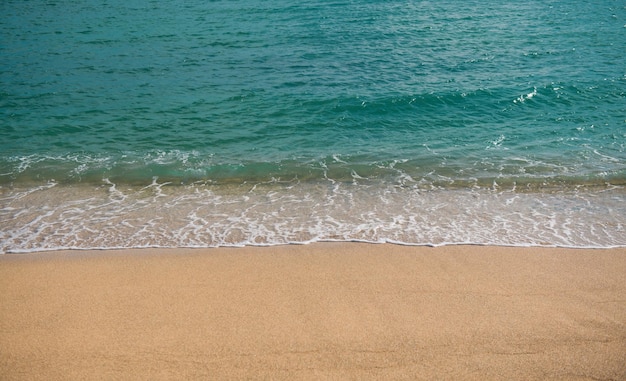 Beach background calm beautiful ocean wave on sandy beach sea view from tropical sea beach