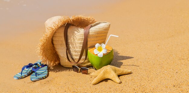 Beach bag and coconut at sea.