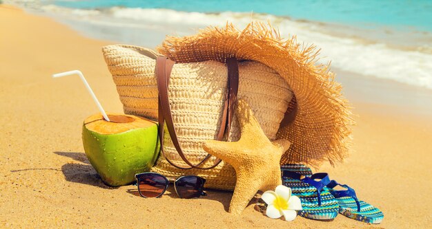 Beach bag and coconut at sea