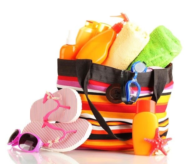 Beach bag with beach accessories isolated on white