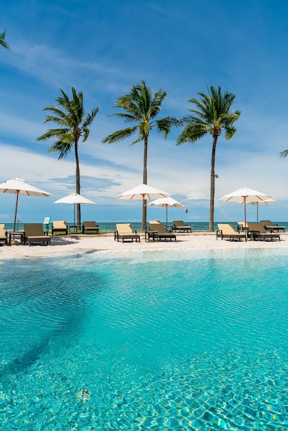 beach chair around swimming pool in hotel resort