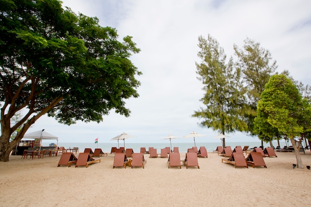 Beach chair and umbrella on sand beach