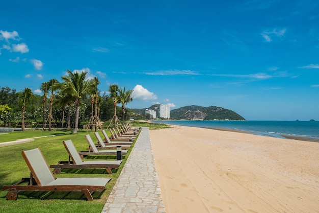 Beach chair with white sand and blue sky