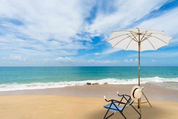 Beach chair with white umbrella tropical beach in summer. vacation and travel concept