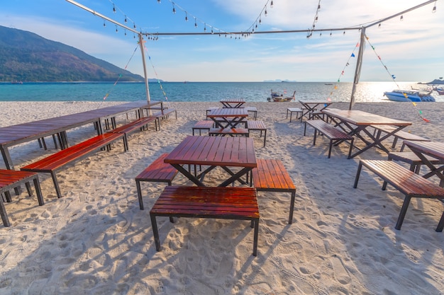 Sedie a sdraio, ombrellone e palme sulla bellissima spiaggia per vacanze e relax all'isola di koh lipe, thailandia