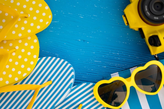 Beach flipflops on blue wooden background