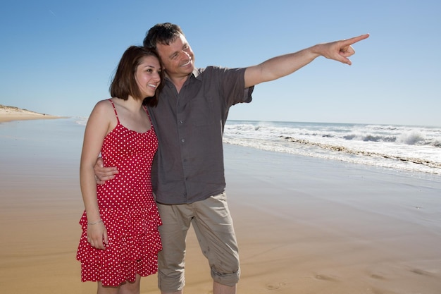 On the beach man pointing hands to show something