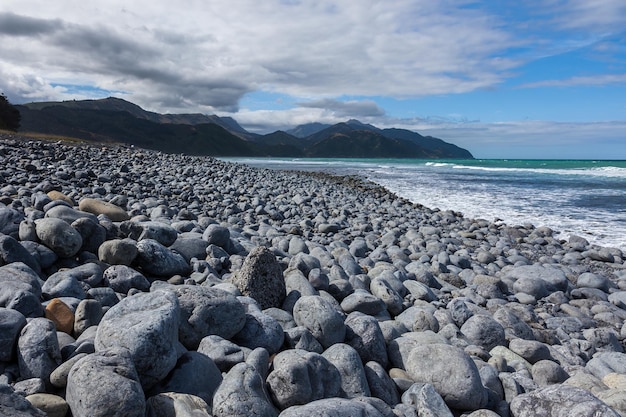 Beach near Mangamaunu strewn with small grey boulders