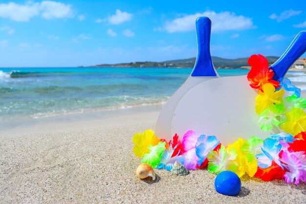 Beach rackets and shells on a tropical beach