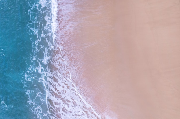 Beach Sand Sea Shore and waves white foamy summer sunny day backgroundAmazing beach top down view overhead seaside nature background