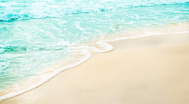 A beach scene with a blue and white sand and the ocean in the background.