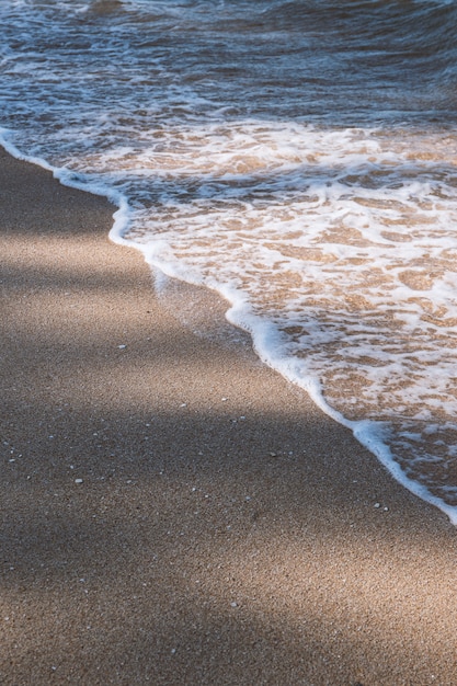 Beach scene with sea waves and sand