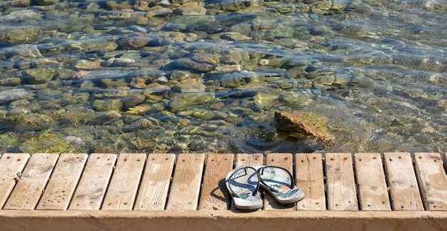 Beach slippers standing on wooden floor