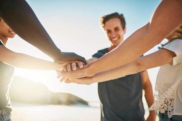 Beach stack and friends with hands together summer and travel with support team building and closeup Group seaside and men with women ocean or cooperation with holiday getaway trip or break