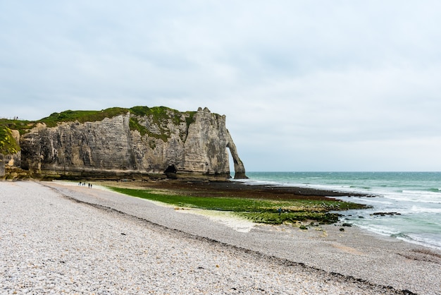 The beach and stone cliffs in Etretat, France, Normandy