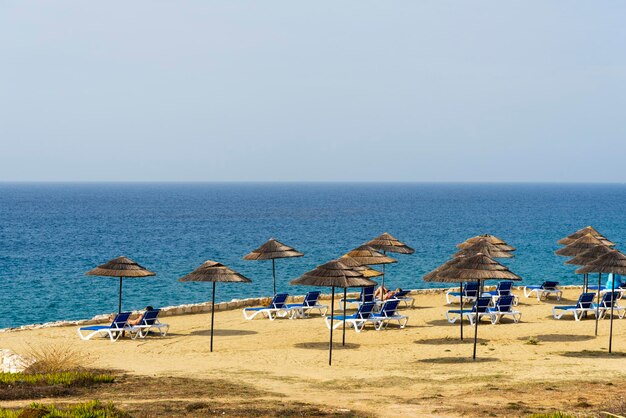 Beach sunbeds and parasols overlooking turquoise water