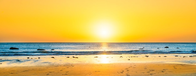 Beach sunset with blue sea