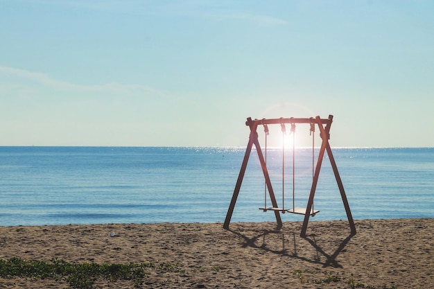 Beach swing in the background of the sea