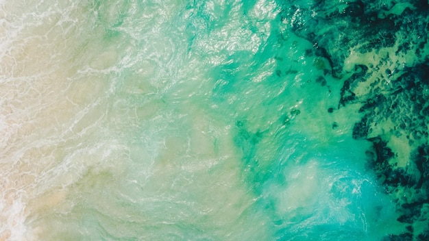 Beach top view with wave foam