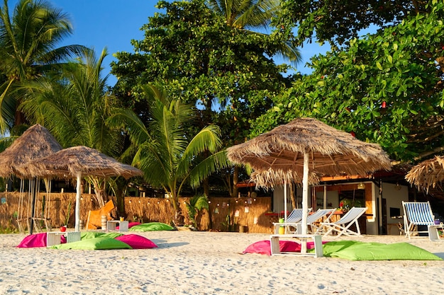 Beach umbrella made of dried palm fronds on a tropical island beach A luxurious vacation concept