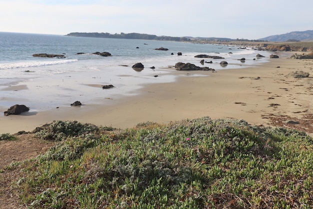 a beach with a beach and rocks in the water