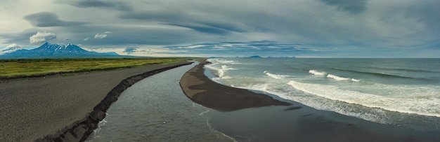 Beach with black sand and volcano