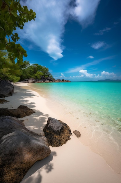 A beach with a blue sky and a white sand beach with a large rock in the middle.